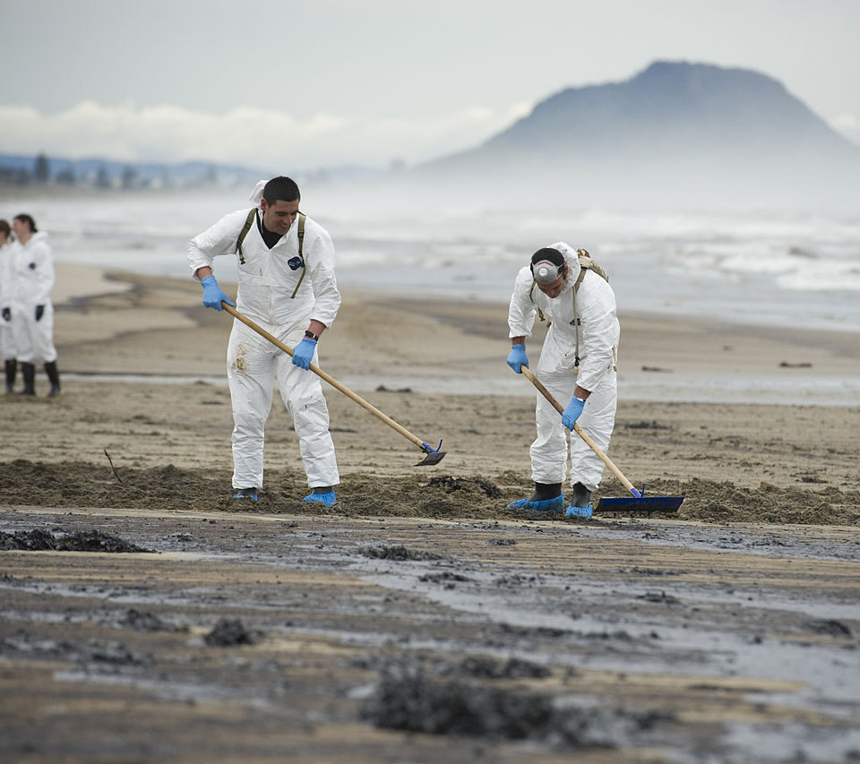Army soldiers cleaning Papamoa Beach after oil from the grounded ship Rena reached shore.