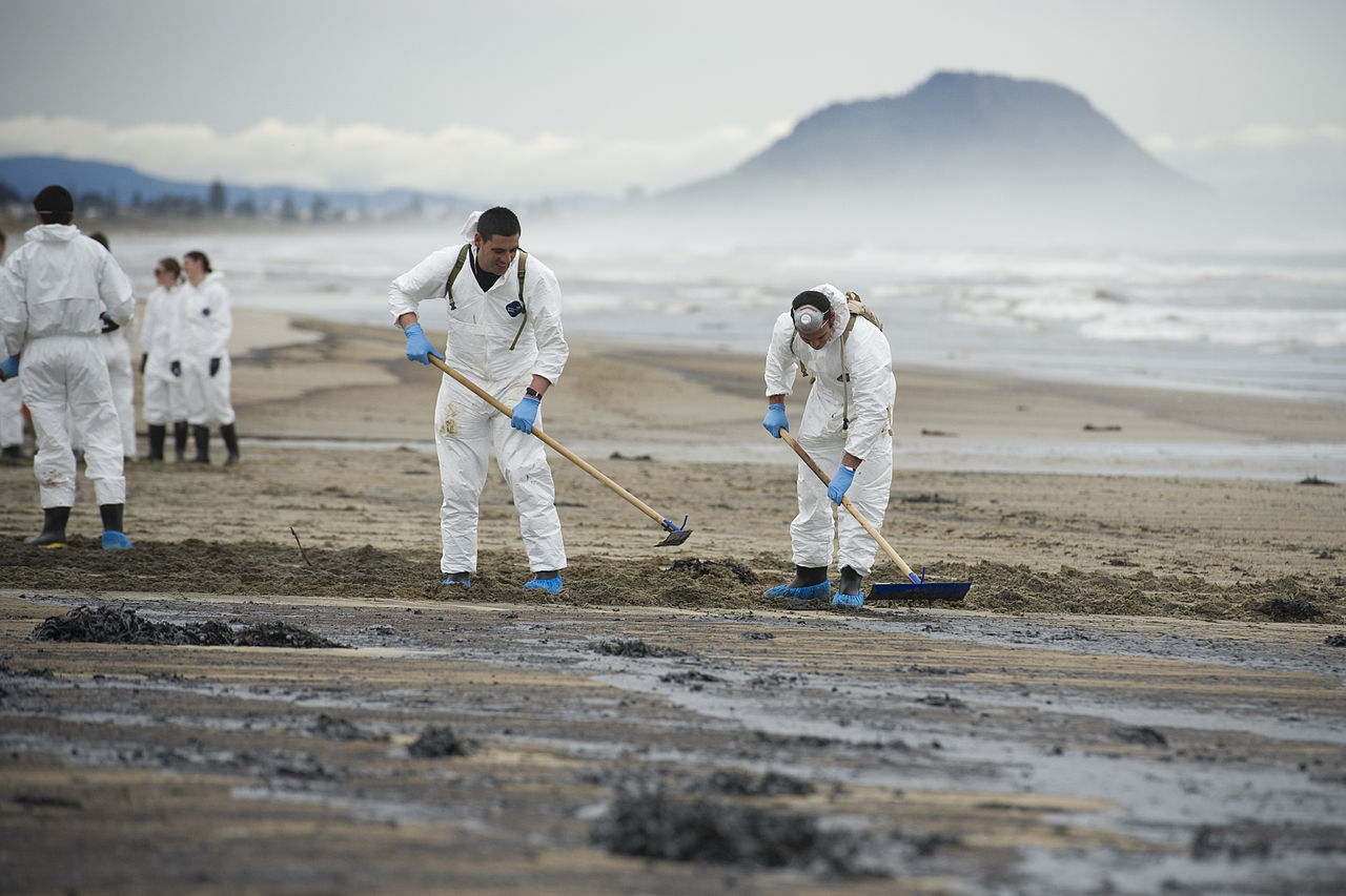 Army soldiers cleaning Papamoa Beach after oil from the grounded ship Rena reached shore.