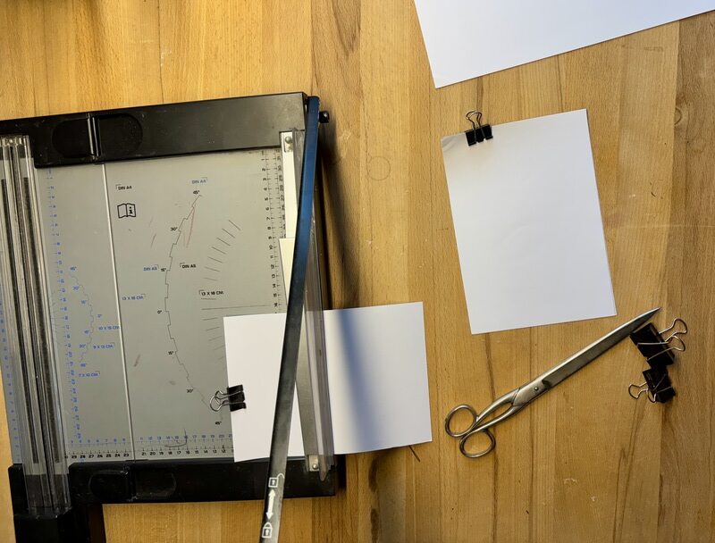 A5 sheets (well, really A4 sheets cut in half), clipped together, in a cutting machine