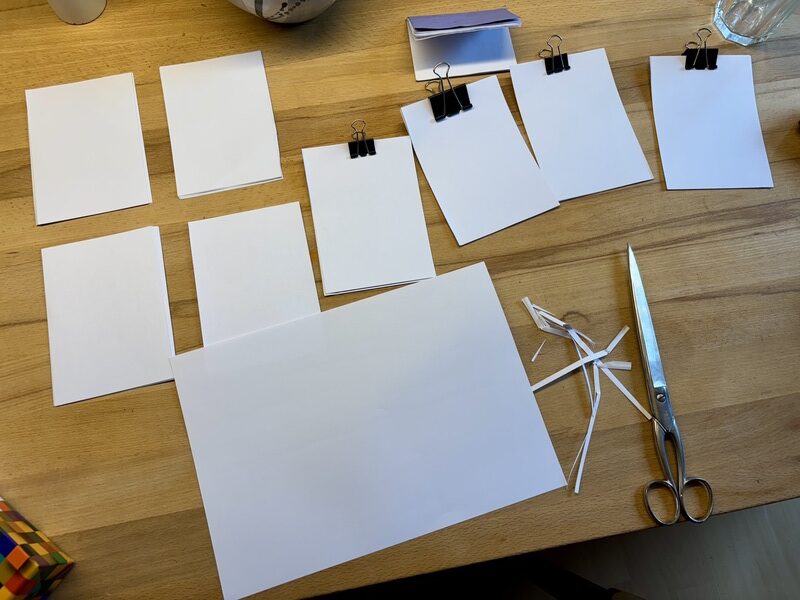 8 piles of cut sheets, some of them clamped together